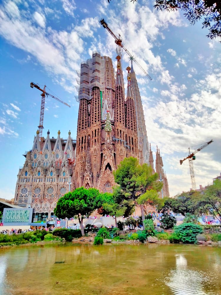 The Sagrada Família seen across the pond in Plaça de Gaudí, Barcelona